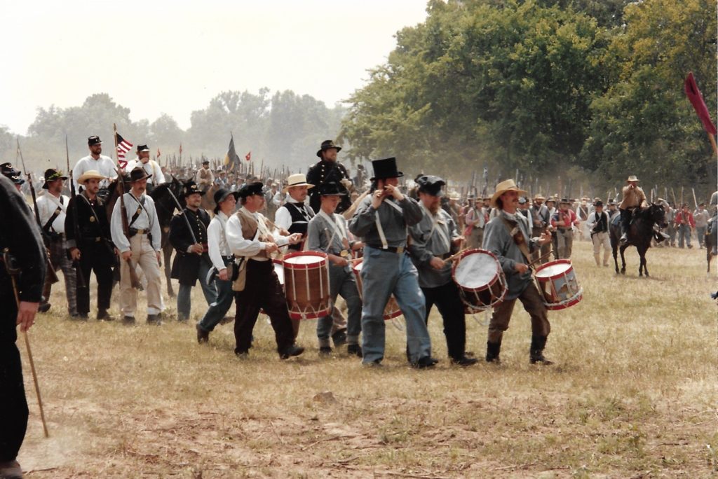 Civil War re-enactors with drums and horses